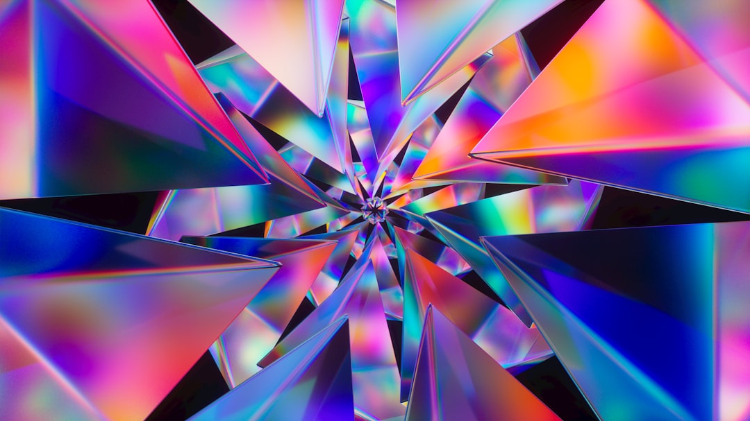 A vivid prismatic geometric pattern with overlapping color shards.