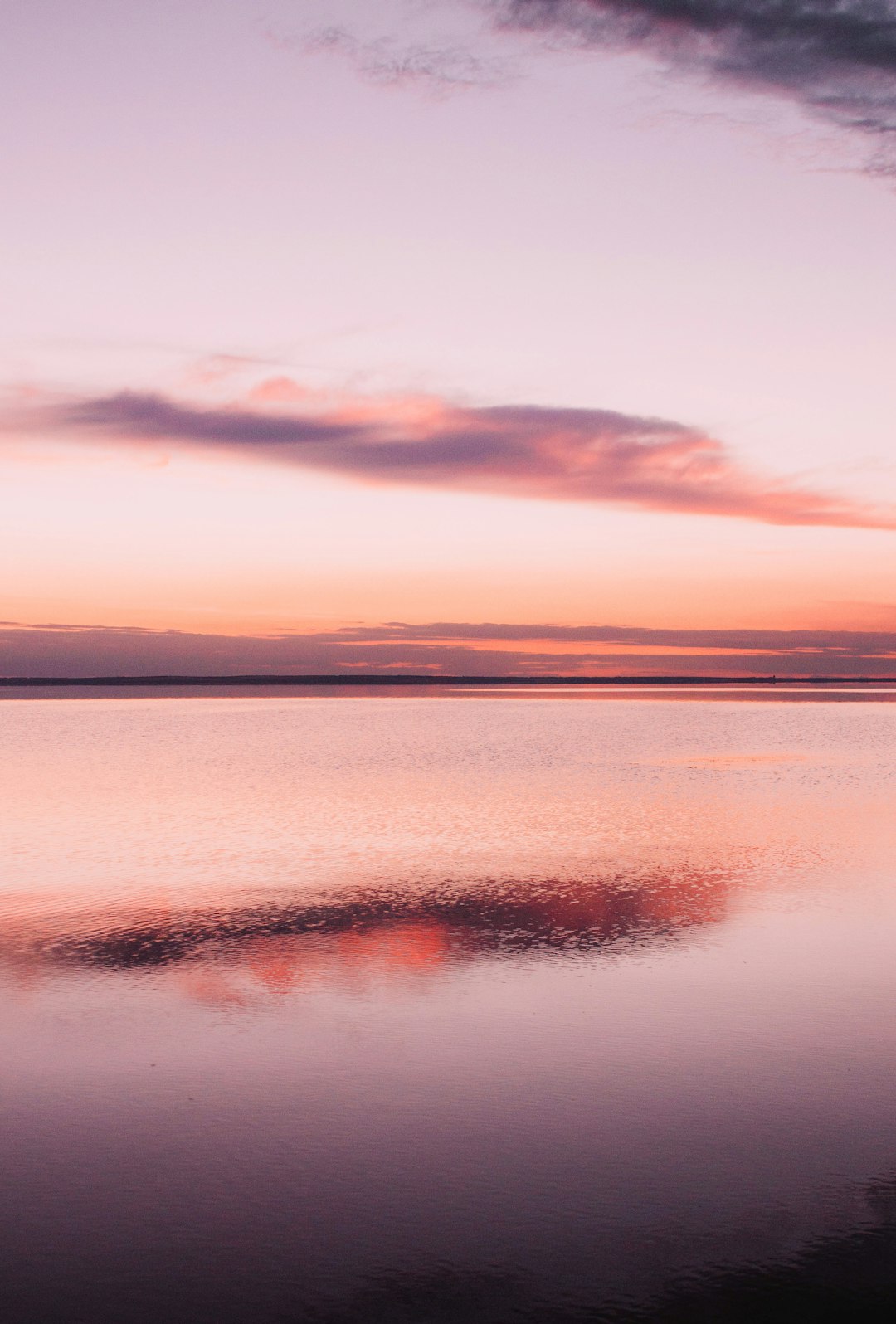 Peaceful water reflection and pastel sky.